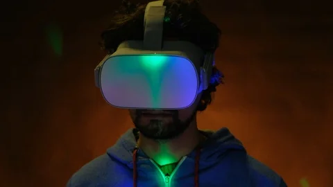 Close-up of young bearded man turning his head around in vr glasses Stock Footage 101431762