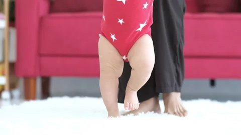 Close up of young biracial mom hold little infant toddler learn walking Vidéo 139657201