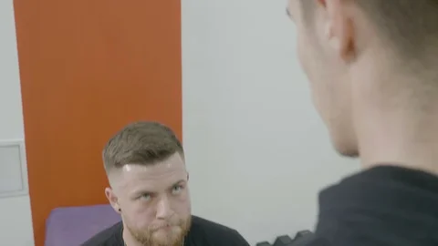 Close up of a young boxer doing intense extra lunges with his coach as a puni Stock Footage 87181365