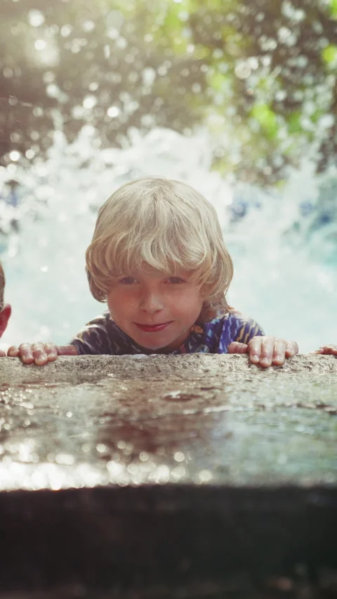 Close-Up Of A Young Boy Doing Flutter Kicks In The Pool Stock Footage 283629202