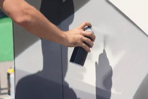 Close up with young boy doing graffiti, holding spray can with hand Fotos de archivo