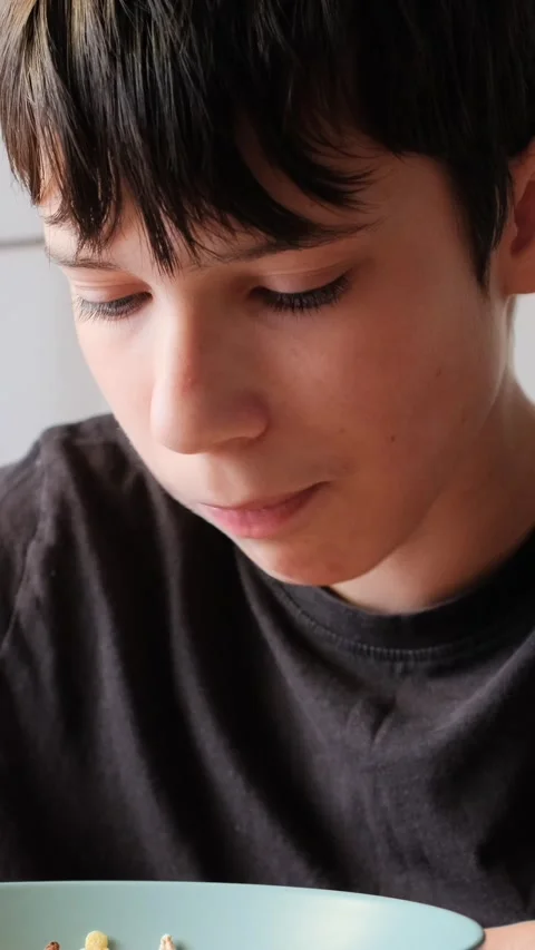 Close-up of a Young Boy Eating Cereal for Breakfast Video stock 326162035