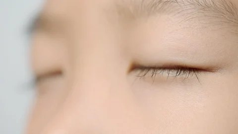 Close up young boy eyes opening Stock-Footage 100459077