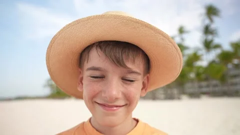 Close up of young boy face in straw hat smiling and looking to the camera on the Stock Footage 279127927