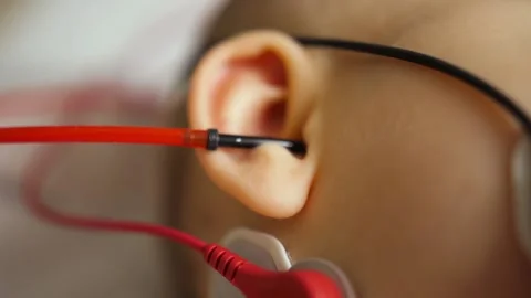 Close up of young boy taking auditory brainstorm response test sensors Stock Footage 225608307