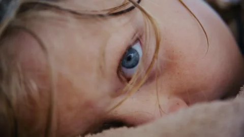 Close-Up of Young Boy With Wet Long Blond Hair Waking Up Stock Footage 344686785
