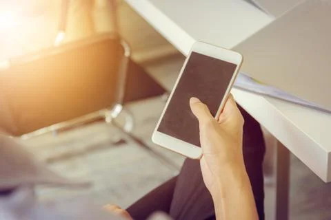 Close up of young business man using mobile smartphone at meeting room Fotos Stock