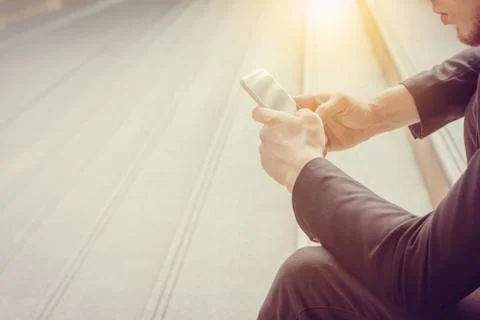 Close up of young business man using mobile smartphone blurry background Stockfoto's