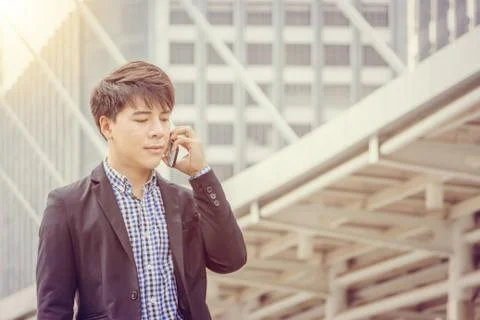 Close up of young business man using mobile smartphone outside office Fotos Stock