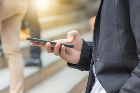 Close up of young business man using mobile smartphone blurry background. Фото