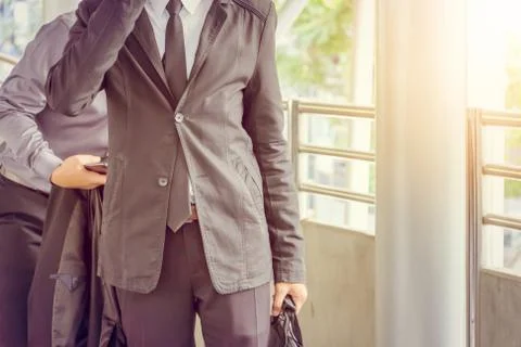 Close up of young business man using mobile smartphone blurry background. Фото
