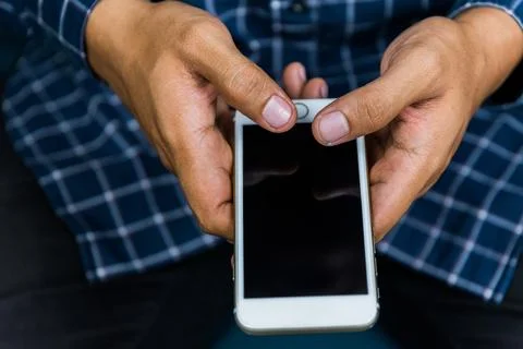 Close up young business man using on cell phone. Stock Photos