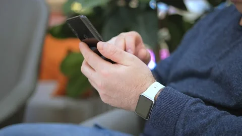 Close up young businessman student worker holding mobile phone in hands texting Stock Footage 236277548