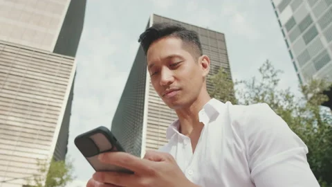 Close up, young businessman using mobile phone from outside Stockbeeldmateriaal 221158681