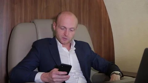 Close Up of a Young Businessman Working Using a Smartphone Stock Footage 135149937