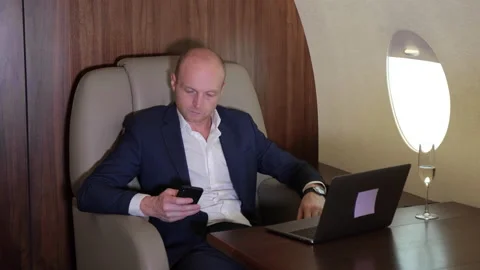 Close Up of a Young Businessman Working Using a Smartphone Doing Business Stock Footage 135149952