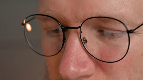 Close-up of young caucasian man in computer glasses looks into laptop. Portrait Stockbeeldmateriaal 198479039