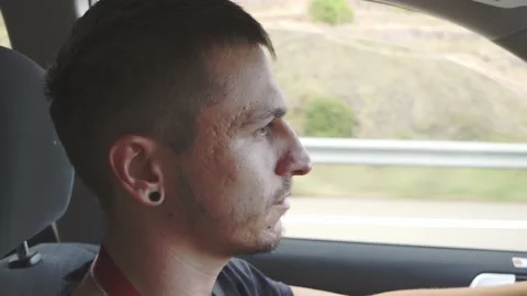 Close-up of young Caucasian man driving a car concentrated Stock Footage 215964237