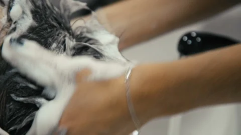 Close-up of a young caucasian man having his hair washed in a hairdressing salon Stock Footage 88100095