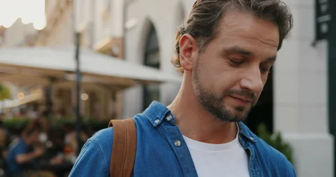 Close up of the young Caucasian man using smartphone device and holding morning Stock Footage 139504880