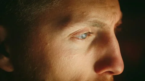 Close up, young caucasian man using laptop at home in the evening Video stock 229639320