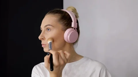 Close up young caucasian model applying professional makeup. Beautiful woman in Stock Footage 112657081