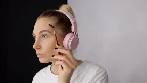 Close up young caucasian model applying professional makeup eyebrows. Beautiful Stock Footage 112657921