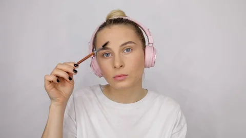 Close up young caucasian model applying professional makeup eyebrows. Beautiful Stock Footage 112662425