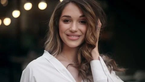 Close up of young charming dark-haired caucasian woman in white shirt smiling Stock Footage 197571628