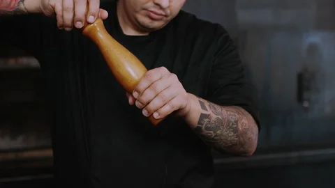 Close up young chef man adds spices to the dish cook food fresh in kitchen Stock Footage 100303817