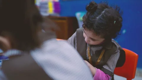 Close-up of a young child writing on a worksheet in a Karachi classroom Stock Footage 329223818