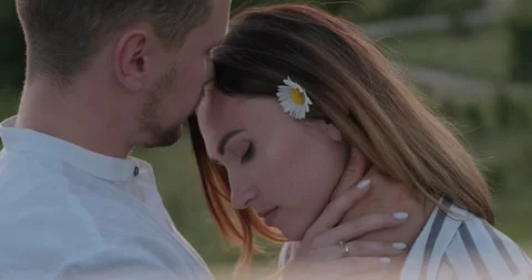 Close-up of young couple enjoying each other in the summer on the nature Stock Footage 136044495