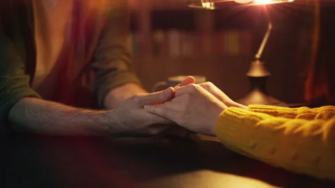Close-up of young couple holding hands during romantic coffee shop date Stock Footage 340266801