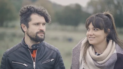 Close up of young couple looking each other and smiling to the camera. Video stock 126423056