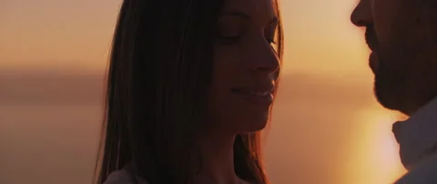 Close up of a young couple looking at each other with love at sunset, with be Stock Footage 136244302