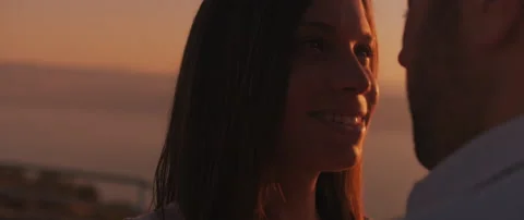 Close up of a young couple looking at each other with love at sunset. Slow mo Stock Footage 136244595