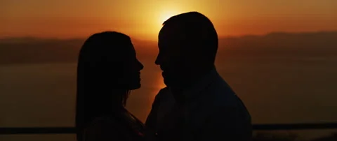 Close up of a young couple looking at each other with love at sunset, smiling Stock Footage 136245119