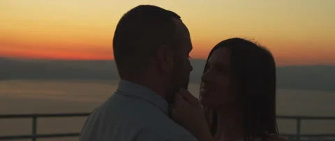 Close up of a young couple looking at each other with love at sunset. Arc sho Stock Footage 136248681