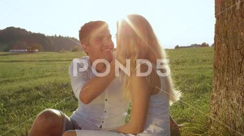 CLOSE UP: Young couple in love gazing at each other on a beautiful sunlit day Stock Photos