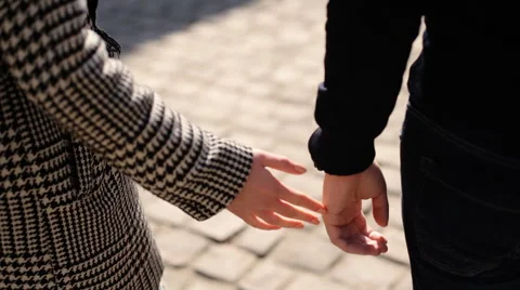 Close up of a young couple in love walking on the street tenderly holding hands Stock Footage 61826321
