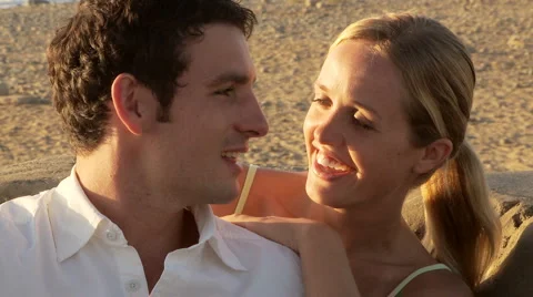 Close up of young couple singing and talking at beach Stock-Footage 934375
