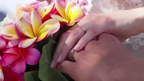 Close up of young couples hands during their Hawaiian beach wedding in Maui. Stock Footage 136266834