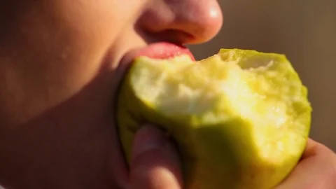 Close-up young cute woman eats green apple. Spring beriberi, vitamins in fruits Stock-Footage 102516470
