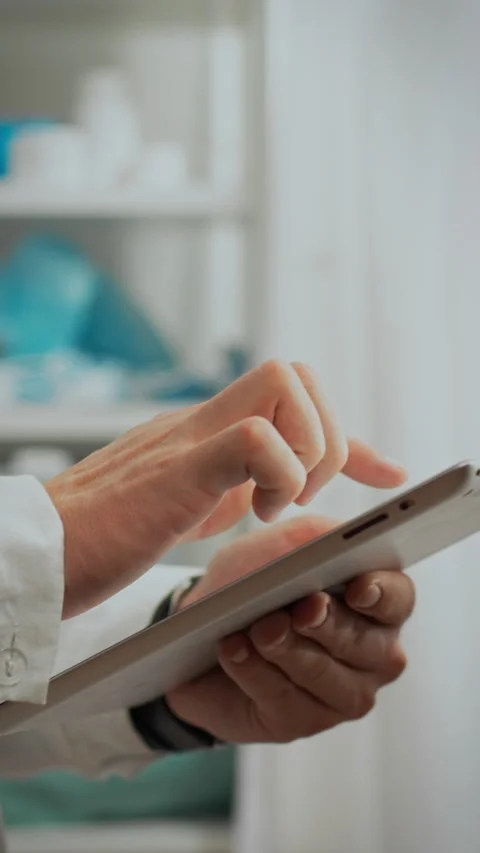 Close-up of a young doctors hand working with a tablet entering information Stock Footage 331538838