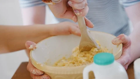 Close Up Of Young Downs Syndrome Couple Mixing Ingredients For Cake Recipe In Stock Footage 114303661