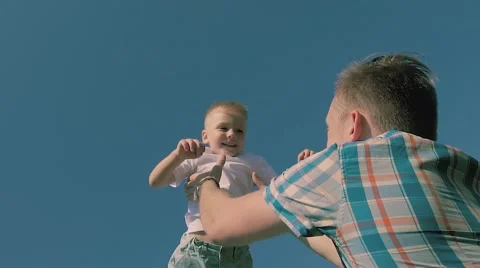 Close-up of young fair-skinned father throwing his son in the air Stock-Footage 68205523