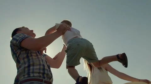 Close-up of young father throwing his child in the air and catches him Stock-Footage 68205844