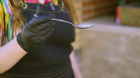 Close-up of young female chef hands in khan atlas holding measuring spoon Stock Footage 333031730