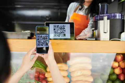 Close-up of young female customer using application in mobile phone Stock Photos