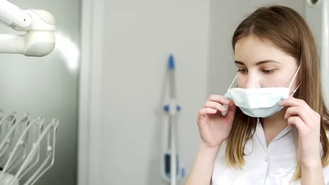 Close up of young female dentist wearing protective glasses at the dentist Stock Footage